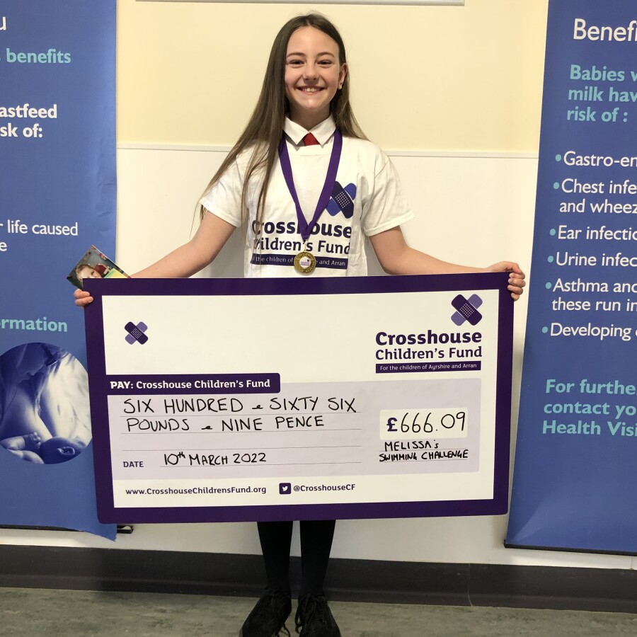 Melissa poses with her cheque to Crosshouse Children's Fund.