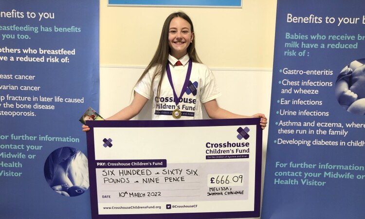 Melissa poses with her cheque to Crosshouse Children's Fund.